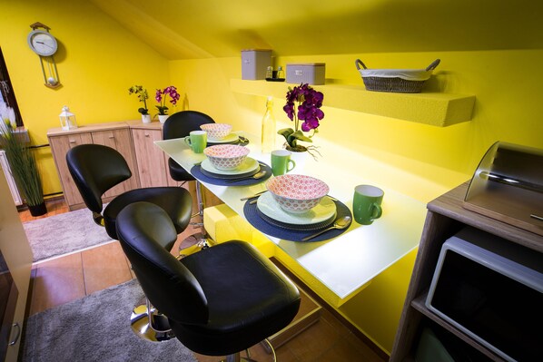 Enjoy meals in this cozy dining area with a table, chairs, and microwave.