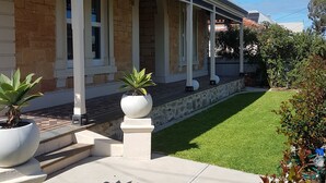 A two-story building with a covered porch and a stone facade. - Semaphore Sea Breeze-Family Beach/Pool Holiday. 450m to Beach. 20 min to airport (Semaphore)
