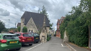 A street with parked cars and a historic building with a pointed roof. - Windsor Town Centre Sleeps 6 (Windsor)