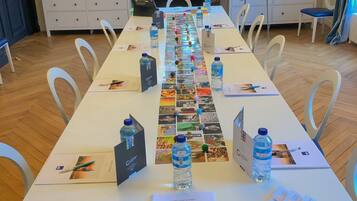 A conference room with a long table, chairs, and a fireplace.