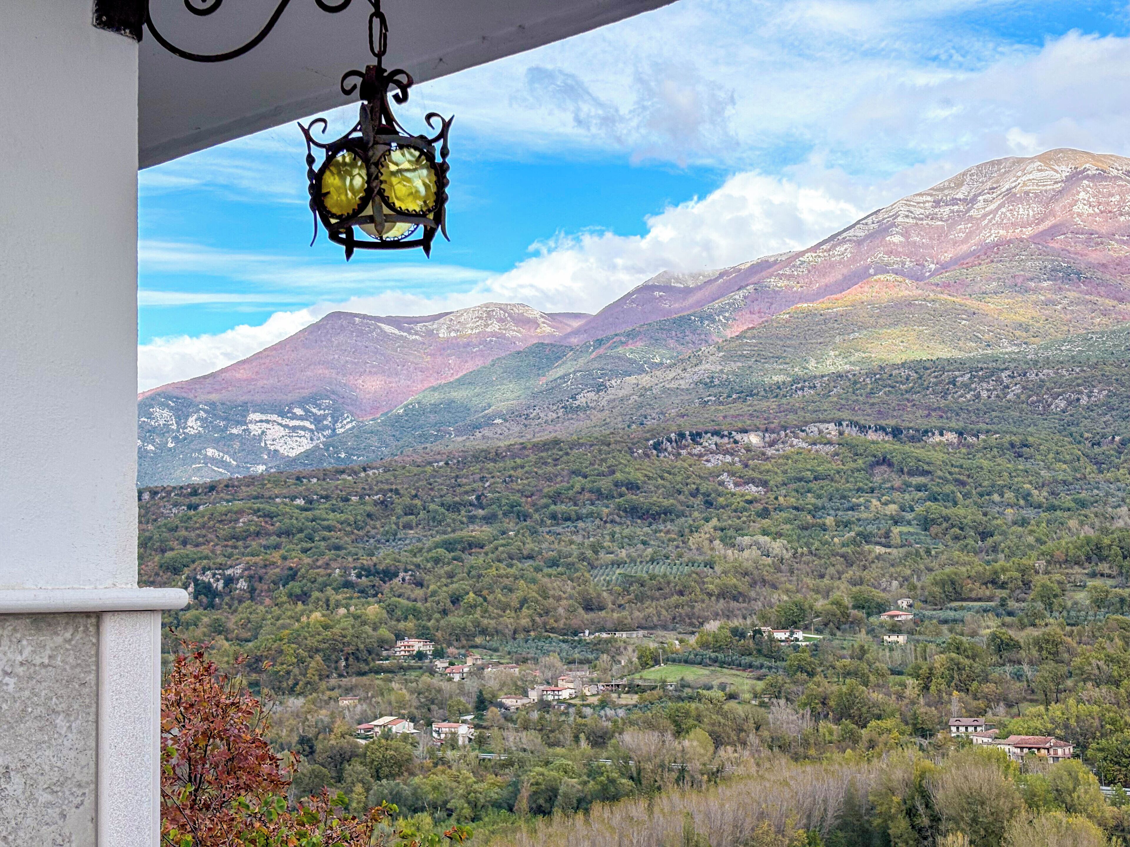 A mountainous landscape with a village in the valley.