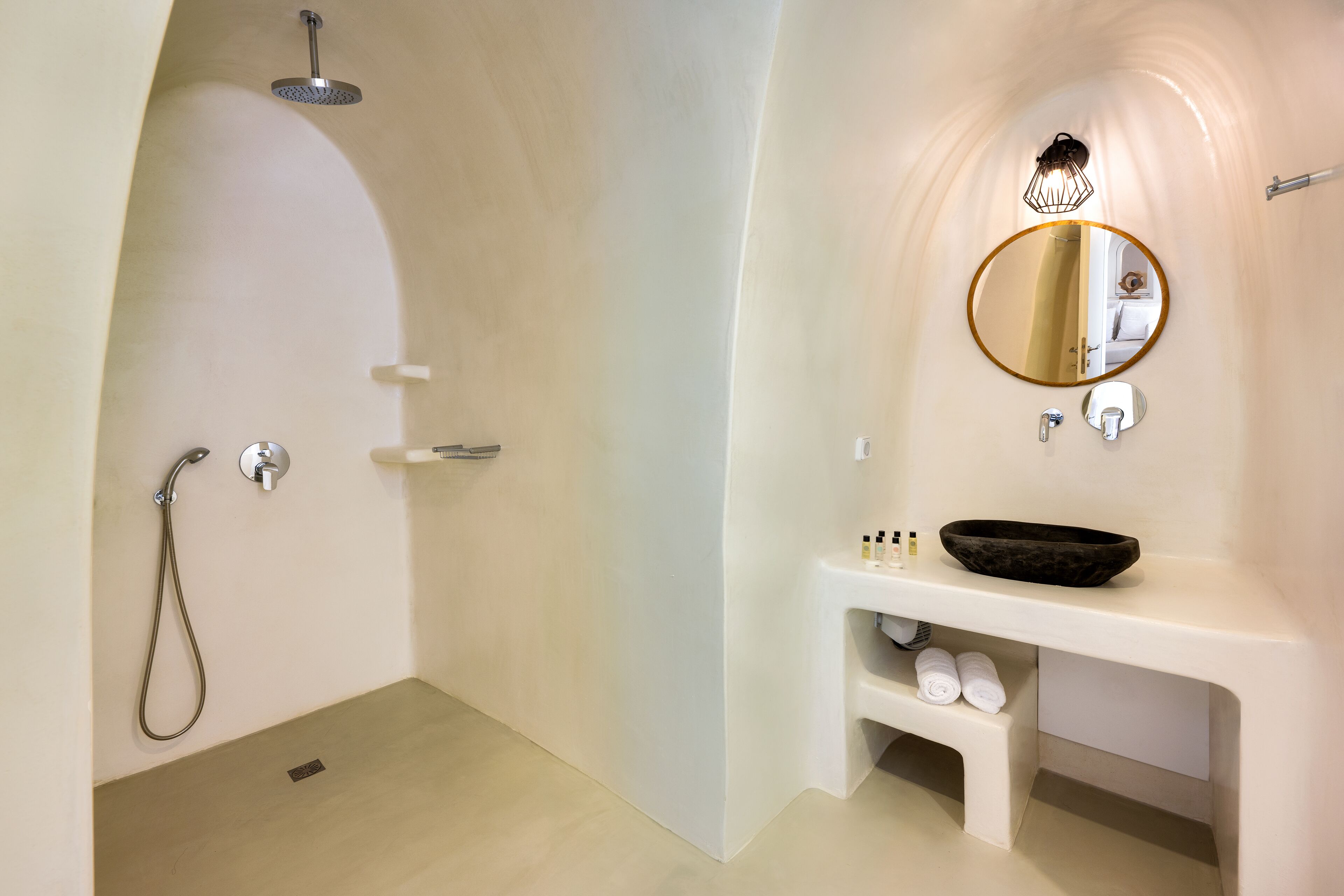 A modern bathroom with a shower, sink, and mirror.