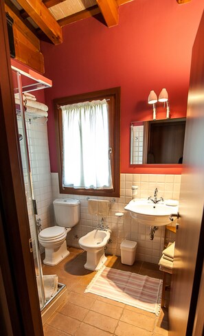A bathroom with a toilet, bidet, and sink.