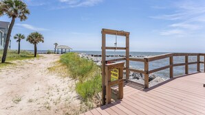 A wooden boardwalk leading to a beach with a sign warning of rocks. - Oceanview, steps from Beach, Pool, Golf course & Restaurant, newly remodeled.  (Saint Helena Island)