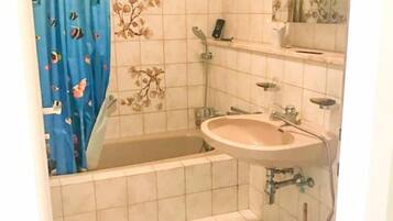 Combined shower/bathtub, towels, soap, toilet paper