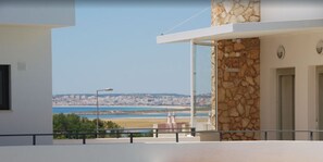 Enjoy breathtaking views of the beach and city from this room's expansive balcony.
