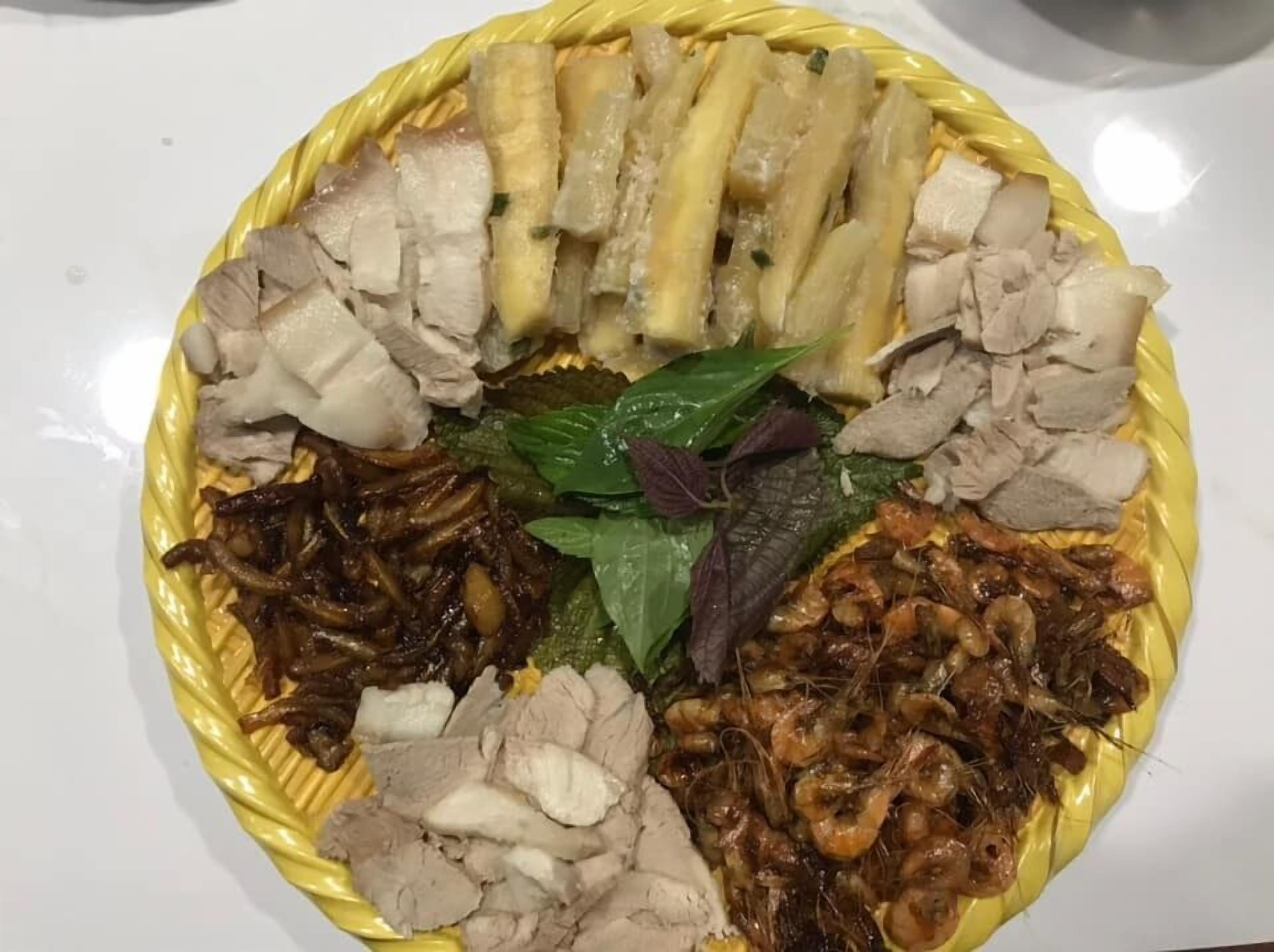A plate of food with various meats and vegetables.