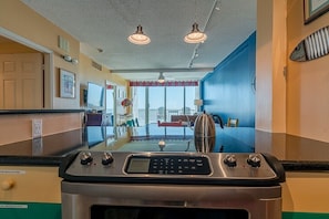 Enjoy a city view from the kitchen window, where a stove with digital controls and modern appliances make cooking a breeze.
