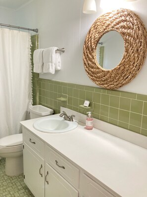 Combined shower/bathtub, towels, soap, toilet paper