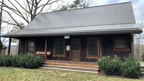 A wooden building with a metal roof, a porch, and a sign that reads "The Pill Box". - The Pill Box is the perfect getaway next to the Cowpasture River (Millboro Springs)