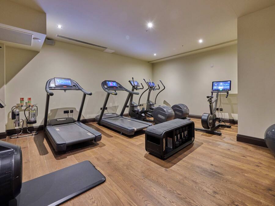 A fitness center with treadmills, elliptical machines, and a stationary bike.