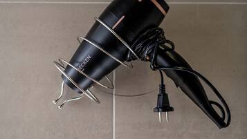 A black power strip with a white wall socket below it.