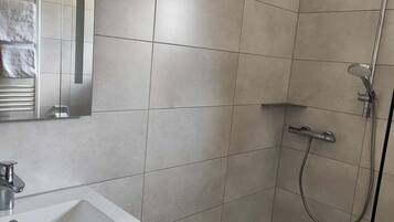 Shower, hair dryer, towels, toilet paper