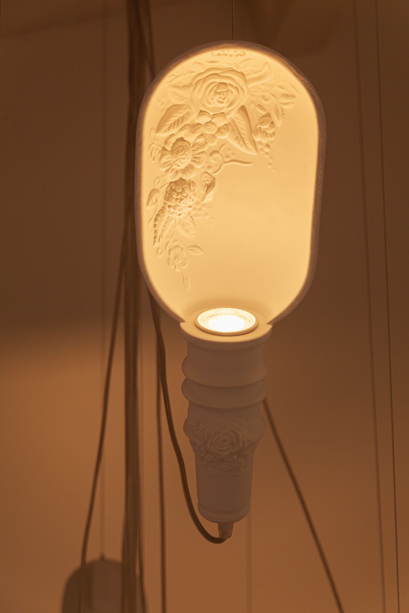 A wall-mounted light fixture with a floral design.