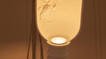 A wall-mounted light fixture with a floral design.