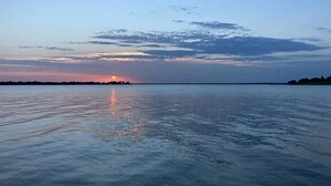 A calm body of water reflecting the sky.