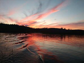 A calm lake at sunset with a forested shoreline. - Lake Front with Amazing Sunsets on McGrath Pond (Oakland)