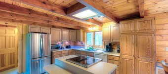 Three-story dog-friendly home with large deck, wood swing, firepit, lawn, & more