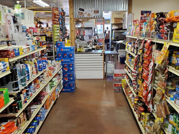 A grocery store with shelves stocked with various products including snacks, beverages, and household items. - Stagecoach Trails RV Resort (Julian)