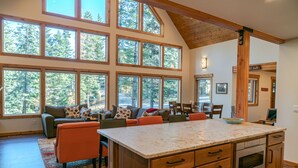 A spacious kitchen with large windows, a wooden ceiling, and a central island. - Mountain Retreat, steps from Skiing, Mountain Biking, and Hiking (Wenatchee)
