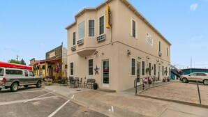 A hotel with a beige facade, multiple windows, and a visible entrance. - Twisters Bed and Breakfast (Guernsey)