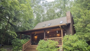 A cabin with a porch, wooden stairs, and a stone wall. - Smokies Hideaway -  2 bdrms/2 bath, private, SECLUDED, BONFIRE pit, Large driveway (Townsend)