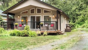 A two-story building with a balcony, surrounded by greenery. - Summer Basecamp: Near Mt Baker, BBQ, AC, Fireplace (Glacier)