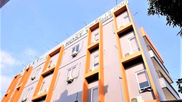 A multi-story building with a sign indicating it is a post office. - Giant Kost (Gading Serpong)