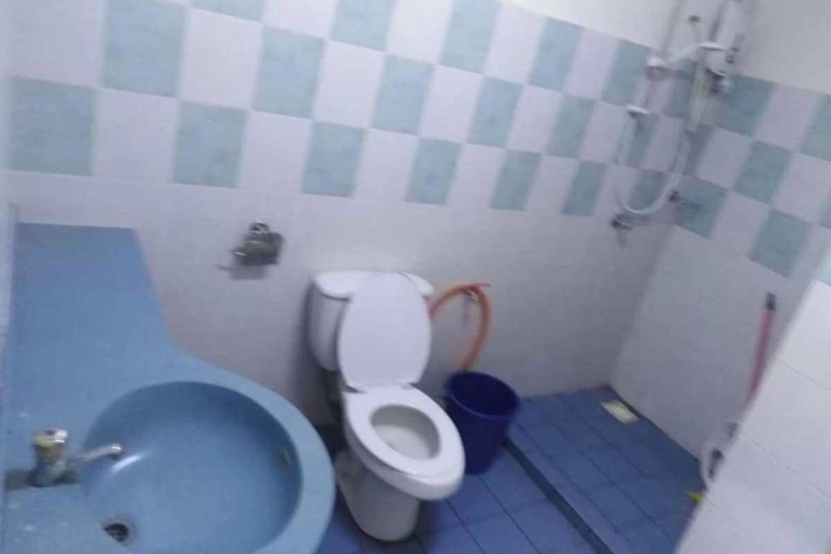 Un bagno con un lavandino blu, un water e uno spazio doccia.