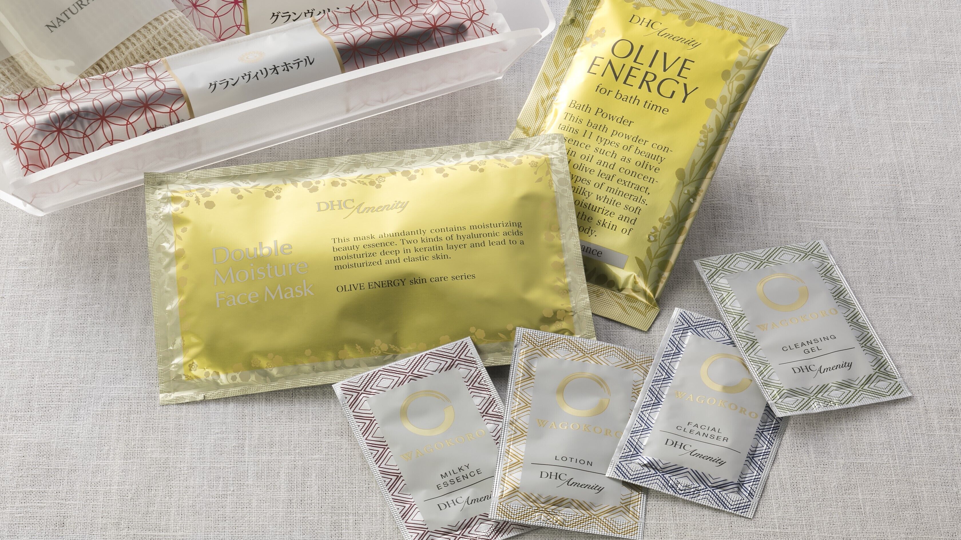 A variety of skincare products including a Double Moisture Face Mask, Olive Energy bath powder, and Wagokoro cleansing gel.