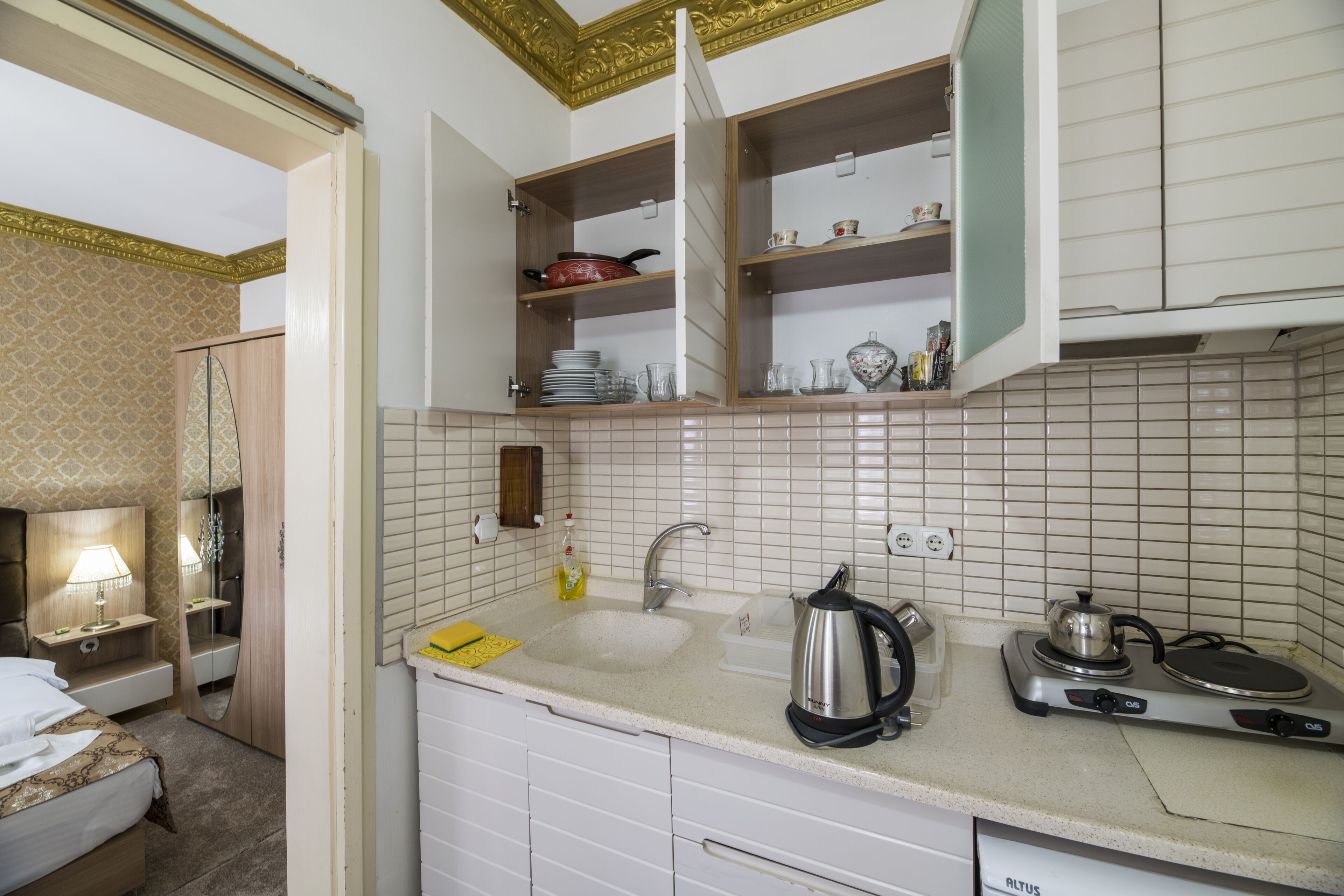 mini-fridge, electric kettle, cleaning supplies, paper towels