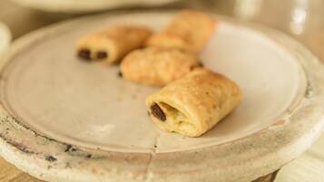 A plate with three pastries on a marble surface.