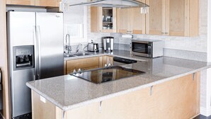 A modern kitchen with a stainless steel refrigerator, a built-in oven, and a microwave. - Spectacular Views and Comfort-Book Now! King Bed! (Chula Vista)