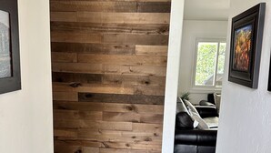 A hallway with a wooden wall and dark wooden flooring. - Spectacular Views and Comfort-Book Now! King Bed! (Chula Vista)