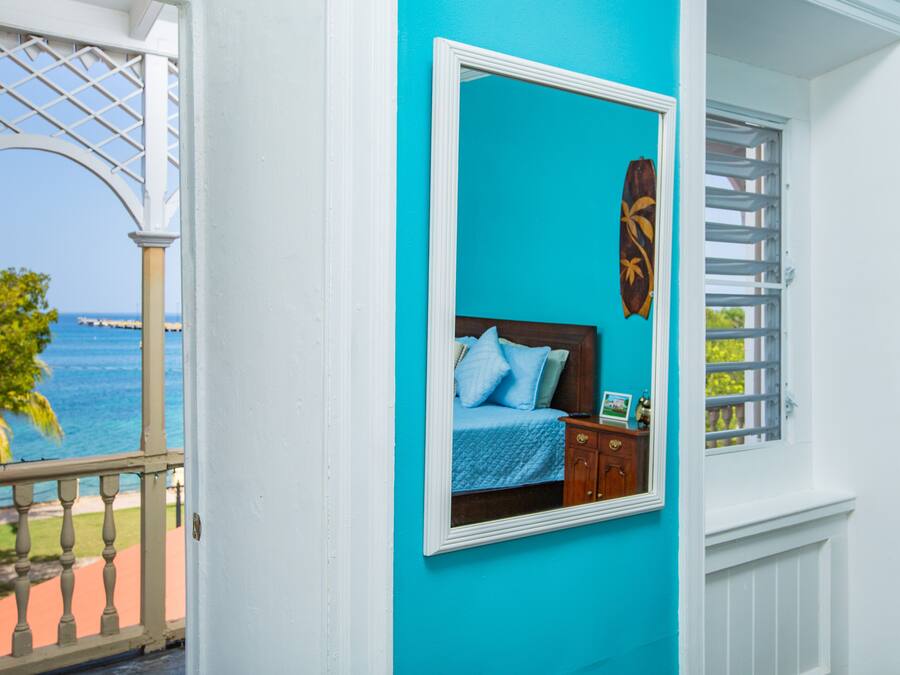 A room with a bed, a nightstand, and a window with blinds.