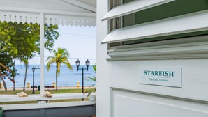 A sign reading "STARFISH Victoria House" on a building facade. - Victoria House (Frederiksted)