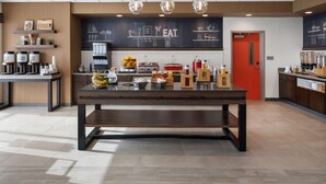 A modern kitchen with a central island, coffee machines, and a chalkboard menu. - Hampton Inn Circleville (Circleville)