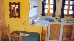 A small kitchen with a dining area.