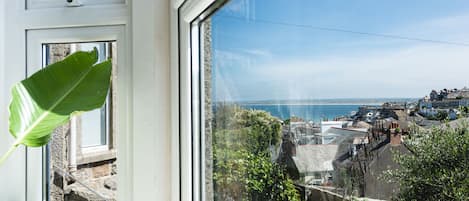 Enjoy breathtaking views of the sea and town architecture from this room's window.