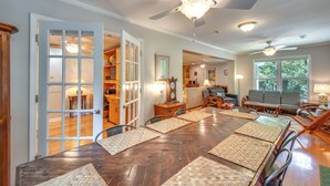 A spacious dining area with a wooden table, woven placemats, and a ceiling fan. - Spacious Lake Hartwell Home w/ Private Boat Dock! (Anderson)