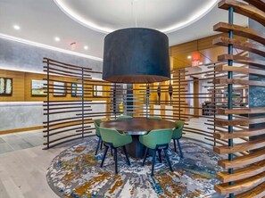 Sit around the central table in this stylish space, surrounded by four chairs and illuminated by a pendant light.