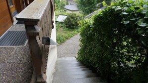 A stone staircase leading to a building with a wooden railing. - Halten (Hofmann) by Interhome (Zweisimmen)