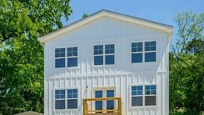 A two-story house with a central entrance, a front porch, and a garage. - Hot Tub! City Side Comfort in Missionary Ridge (Chattanooga)