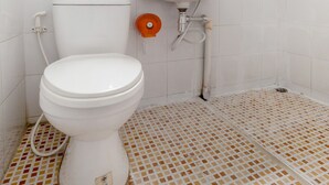 A bathroom with a toilet, sink, and shower.