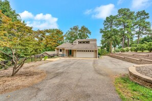 A single-story house with a garage, surrounded by trees and a driveway. - Break Away - sleeps 12, kayaks, SUP's fire pit, games galore! Great for kids and adults! (Moneta)