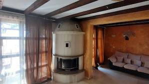 A narrow room with a wooden floor, a white cabinet, and a window with blinds. - Beautiful 2-bed Villa in Cholakova Cheshma (Kosharitsa)