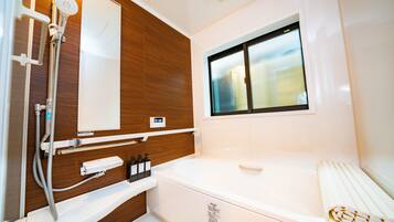 Separate bathtub and shower, free toiletries, hair dryer, slippers