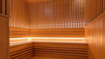 A wooden sauna with slatted walls and benches.