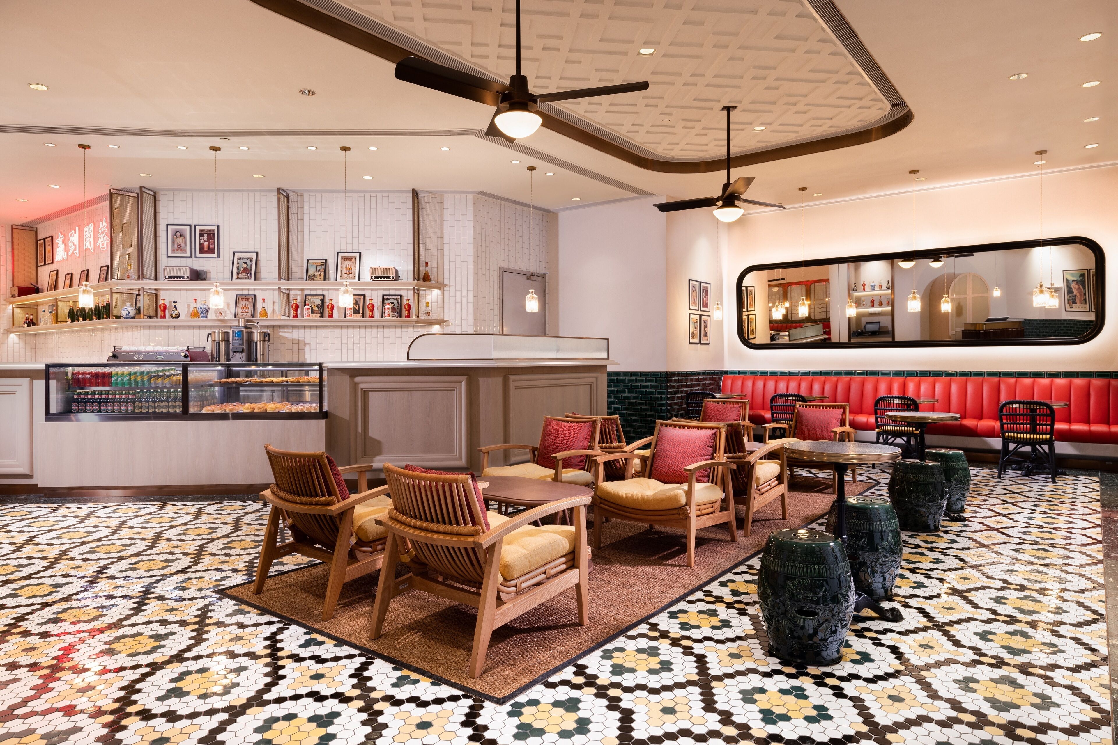 A hotel lobby with a bar area, seating arrangements, and a patterned floor.