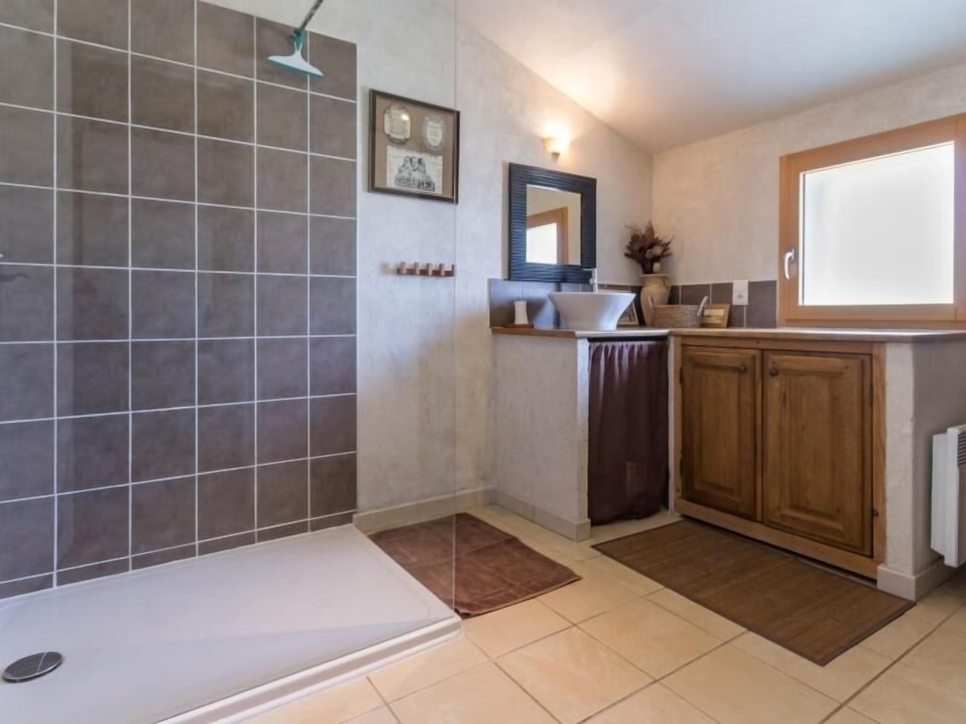 A bathroom with a shower, a sink, and a toilet.